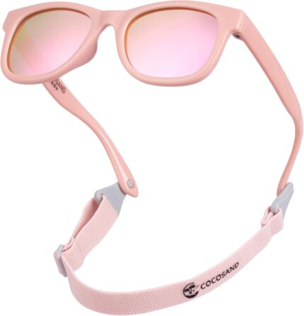 Bright pink COCOSAND flexible polarized baby sunglasses with an adjustable strap, shown on a white background.