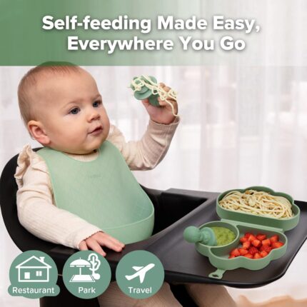 A haakaa Cloud Crew 5-piece green silicone baby travel feeding set with a foldable plate, bib, spoon, fork, and travel bag.