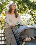 Black liuliuby magnetic phone holder for strollers and carts, securely attached to a handlebar.