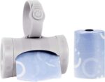 Gray retractable diaper bag dispenser with a roll of lavender-scented bags, clipped to a stroller handle.