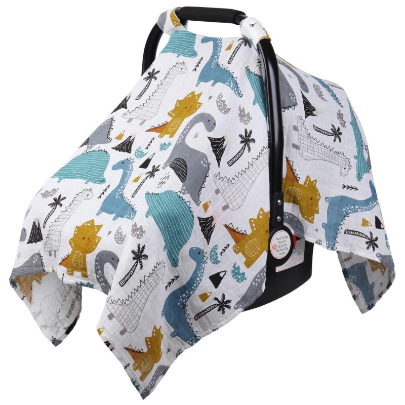 Close-up of a Rquite muslin car seat cover with a dinosaur pattern, draped over an infant car seat.