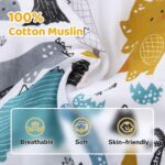 Close-up of a Rquite muslin car seat cover with a dinosaur pattern, draped over an infant car seat.