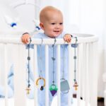 Six blue silicone baby toy straps with animal designs, shown attached to pacifiers and toys on a high chair and stroller.