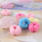 A pile of colorful WDGROW mini hair ties, suitable for babies, toddlers, and adults with fine hair, in a resealable bag.